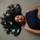 Artistic overhead maternity photoshoot with flowers in hair; unique maternity photo and pregnancy photo from a maternity shoot.