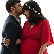 Intimate pregnancy photoshoot showing man kissing forehead; beautiful pregnancy photo for a maternity shoot.