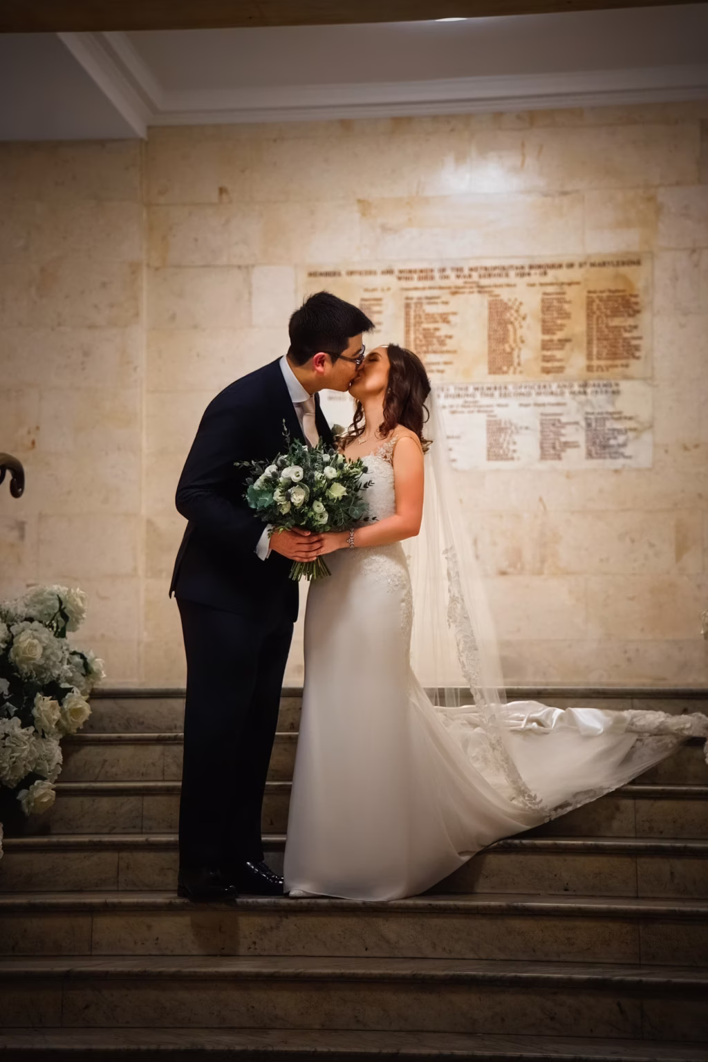 A couple with a bouquet after their ceremony