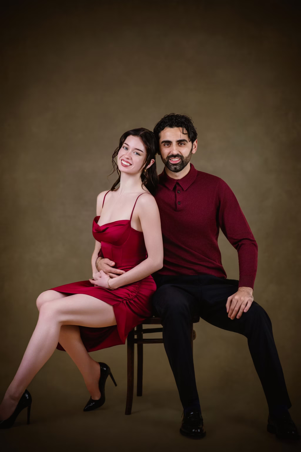 A couple in a studio portrait against a soft backdrop