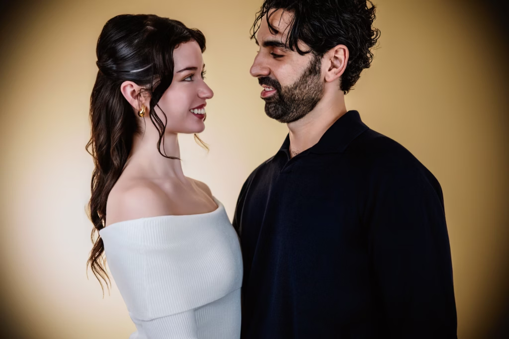 london couple photography profile view portrait of couple looking at each other and smiling, woman in white off shoulder top and man in dark shirt against warm vignetted background