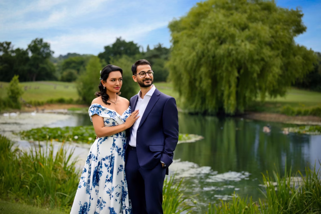 London family picture of couple in formal attire by lakeside with willow tree