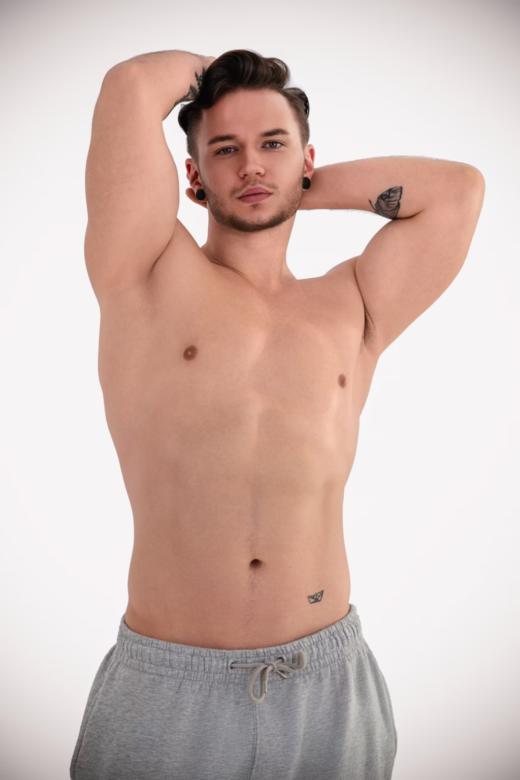 London modeling headshots - fashion photographer london, High-key studio portrait shirtless man both hands behind head grey drawstring sweatpants bright even lighting highlighting physique small tattoos arms waist