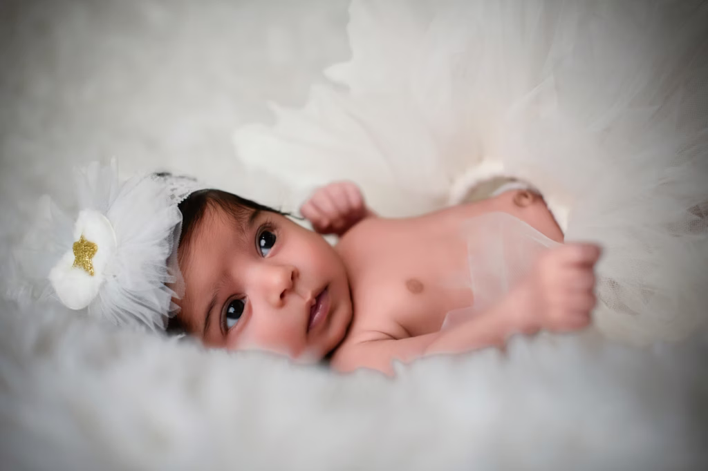 A newborn resting on a soft blanket