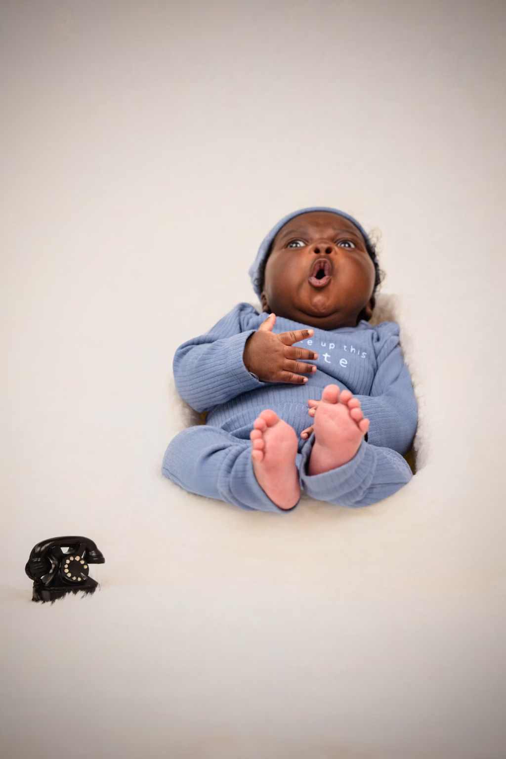 A newborn posed gently in the studio