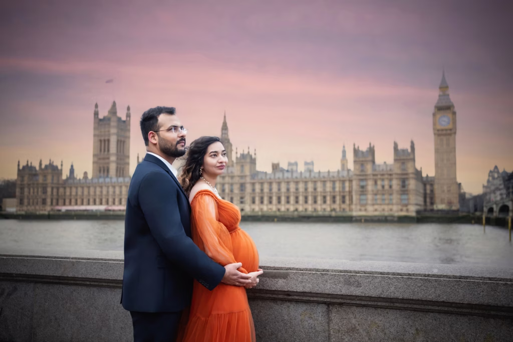 Expectant couple by the River Thames near the Houses of Parliament