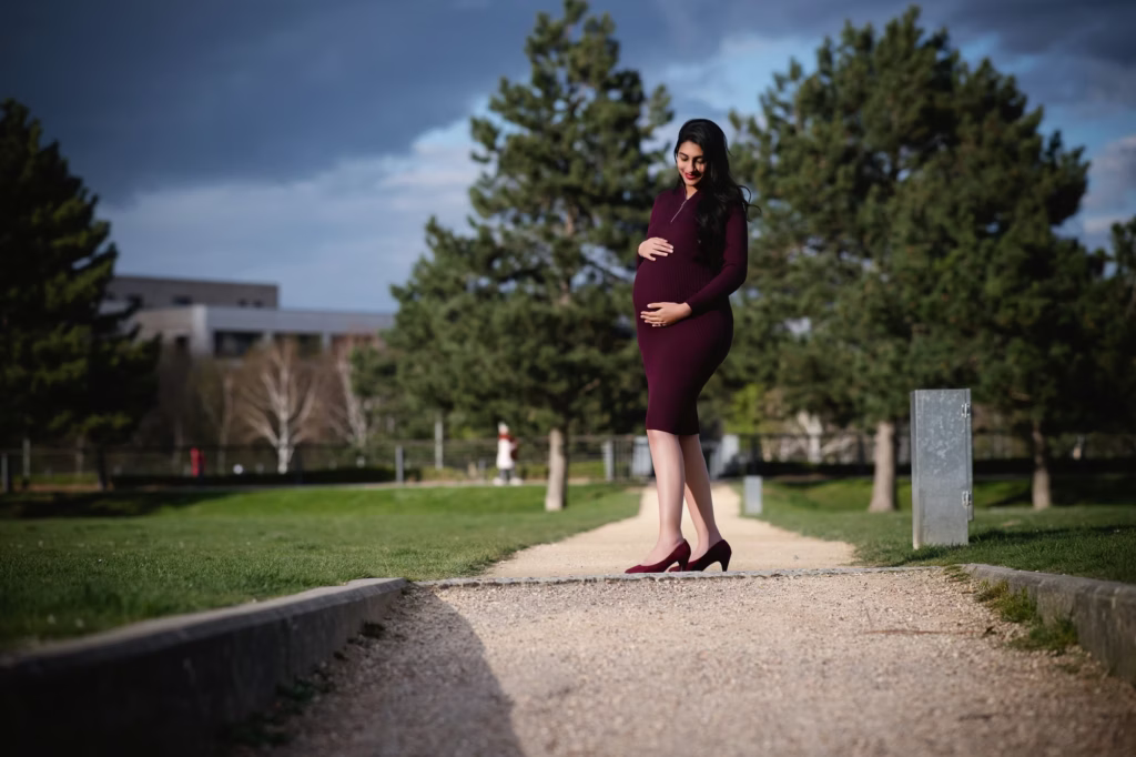 Expectant mother on a tree-lined park path in London