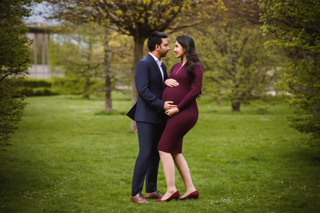 Expectant couple in a London park among autumn trees