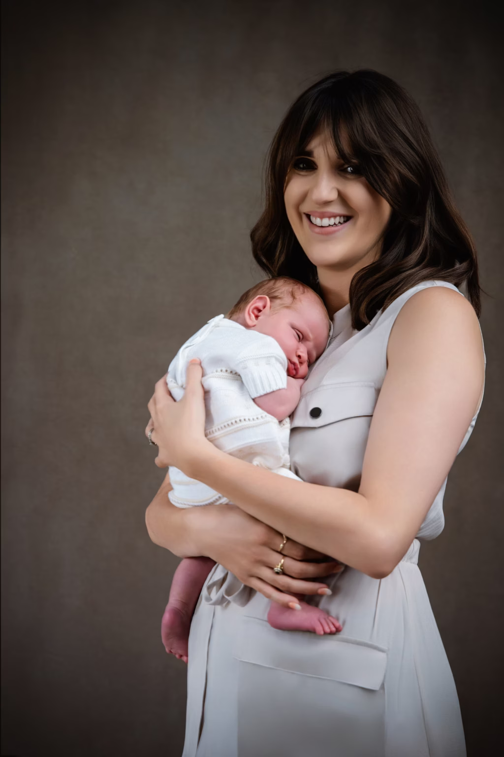 A mother cradling her newborn